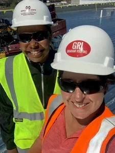 Two Women posing in their hard hats